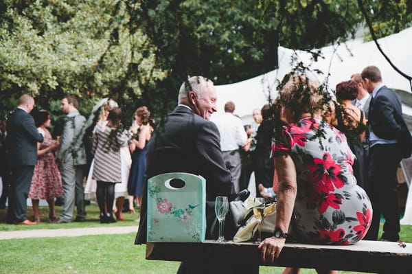 Wedding guests sitting in garden of The Wood Lane Countryside Centre - Picture by McKinley-Rodgers Photography