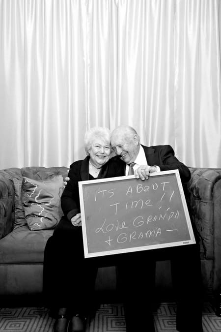 Grandparents with chalk board message - Picture by Yvette Roman Photography