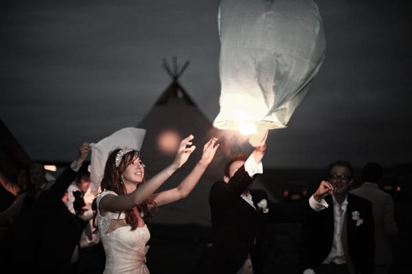 Bride and groom releasing Chinese lantern - Picture by Archibald Photography