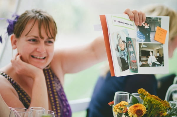 Wedding guest holding up book - Picture by McKinley-Rodgers Photography