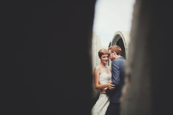 Picture of a bride and groom taken through a gap - Picture by Josh Dookhie Photography