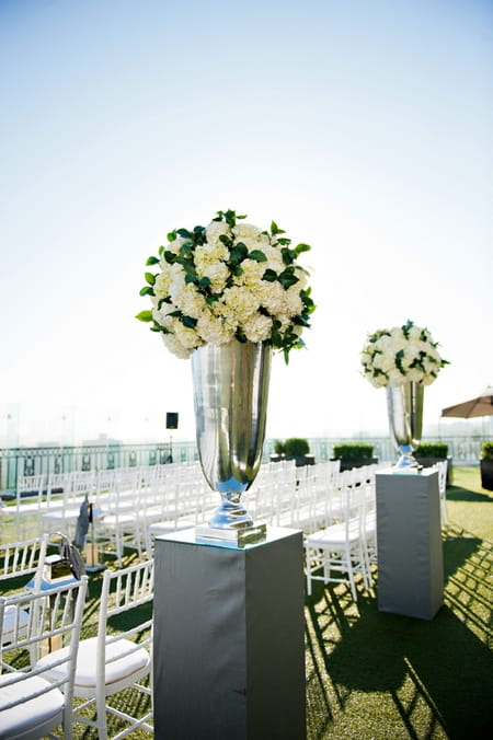 Silver vases of wedding flowers - Picture by Yvette Roman Photography