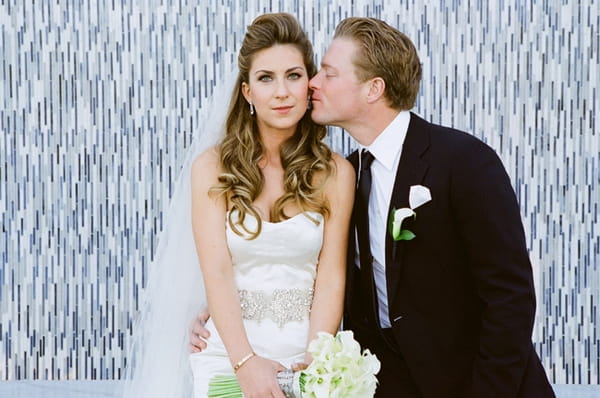 Groom kissing bride on the cheek - Picture by Yvette Roman Photography