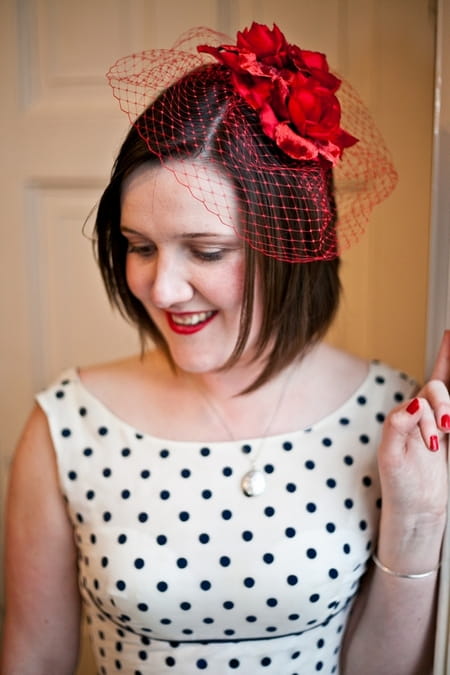 Bride with red birdcage fascinator and blue polka dot dress - Picture by Anneli Marinovich Photography