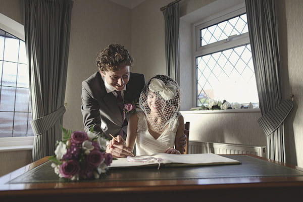 Bride and groom signing the register - Picture by York Place Studios