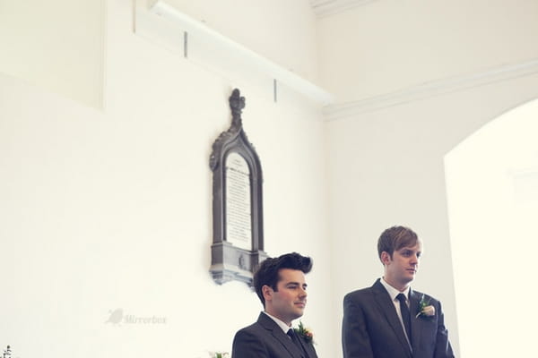 Groom and best man waiting in church - Picture by Mirrorbox Photography