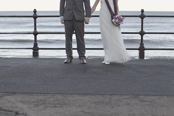Bride and groom's legs by the sea - Picture by York Place Studios