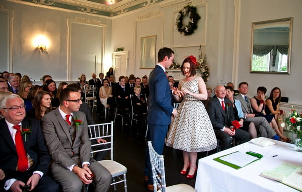 Bride placing ring on groom's finger - Picture by Anneli Marinovich Photography