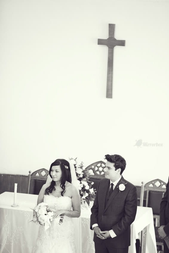 Bride and groom standing by altar - Picture by Mirrorbox Photography