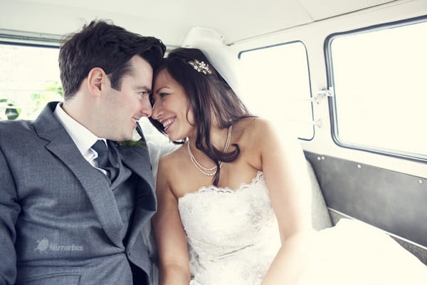 Bride and groom in back of VW camper van - Picture by Mirrorbox Photography