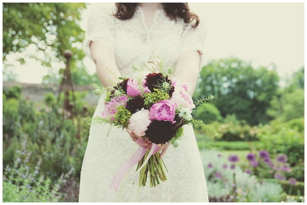 Bride holding bouquet of purple flowers - Picture by Fiona Kelly Wedding Photography