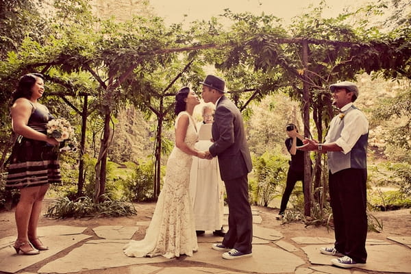 Bride and groom kissing during vintage wedding ceremony - Picture by Paco and Betty