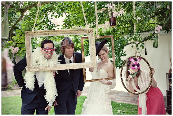 Wedding guests posing in picture frames - Picture by Marianne Taylor Photography