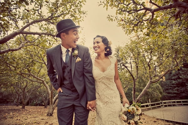 Vintage bride and groom holding hands and laughing - Picture by Paco and Betty