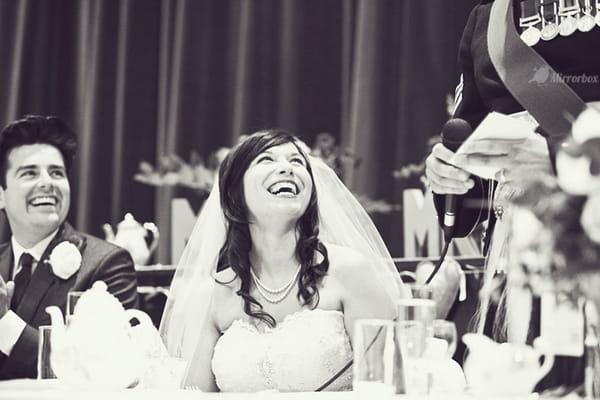 Bride laughing at wedding speech - Picture by Mirrorbox Photography