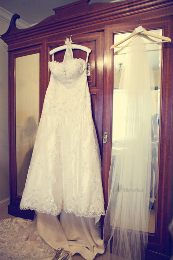 Vintage wedding dress hanging on wardrobe - Picture by Mirrorbox Photography