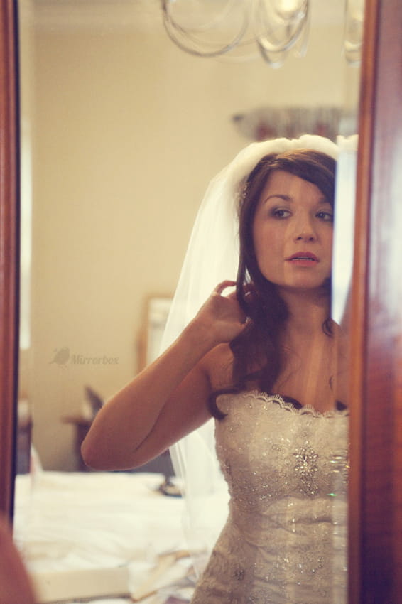 Bride looking in mirror - Picture by Mirrorbox Photography