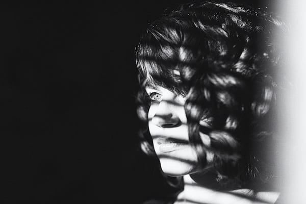 Black and white picture of woman with curly hair - Picture by York Place Studios
