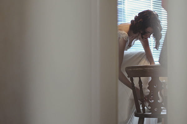 Bride putting on wedding shoe - Picture by York Place Studios