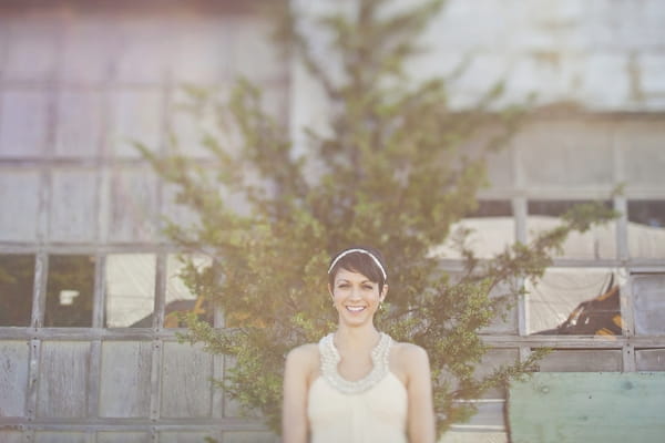 Bride standing in front of tree - Picture by Our Labor of Love Photography