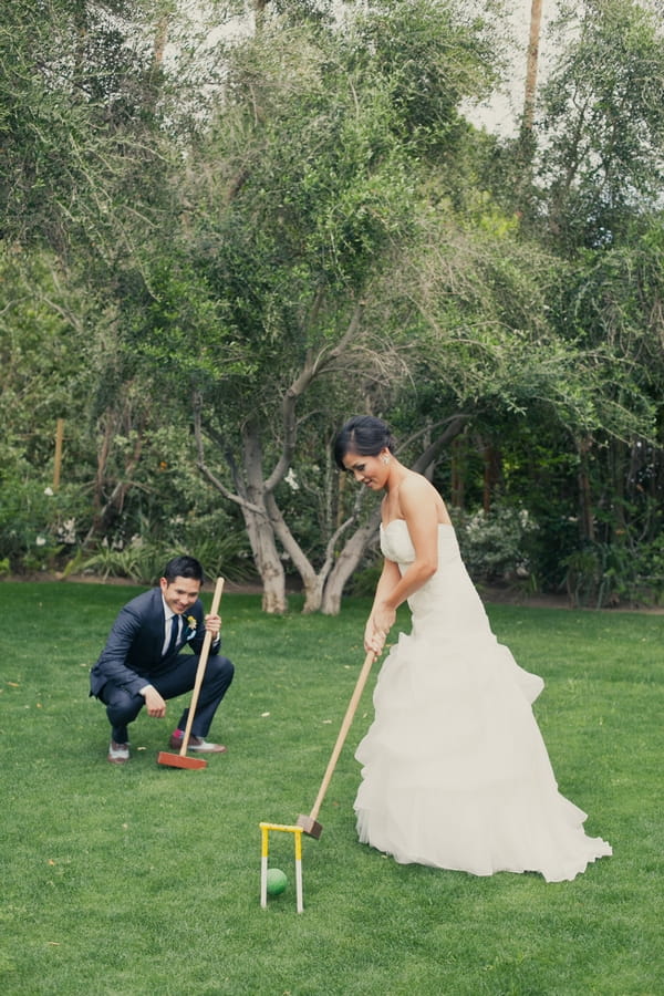 Bride and groom playing croquet - Picture by onelove photography