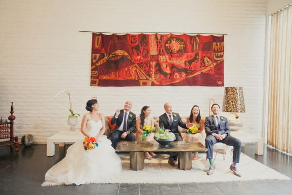 Bridal party sitting on sofa - Picture by onelove photography