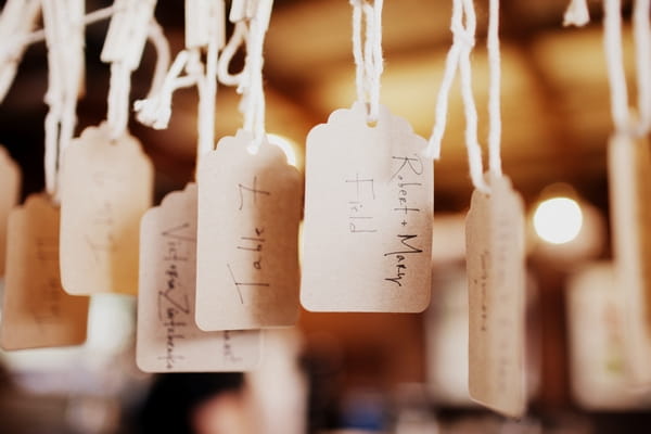 Wedding table numbers hanging from pegs - Picture by Judy Pak Photography