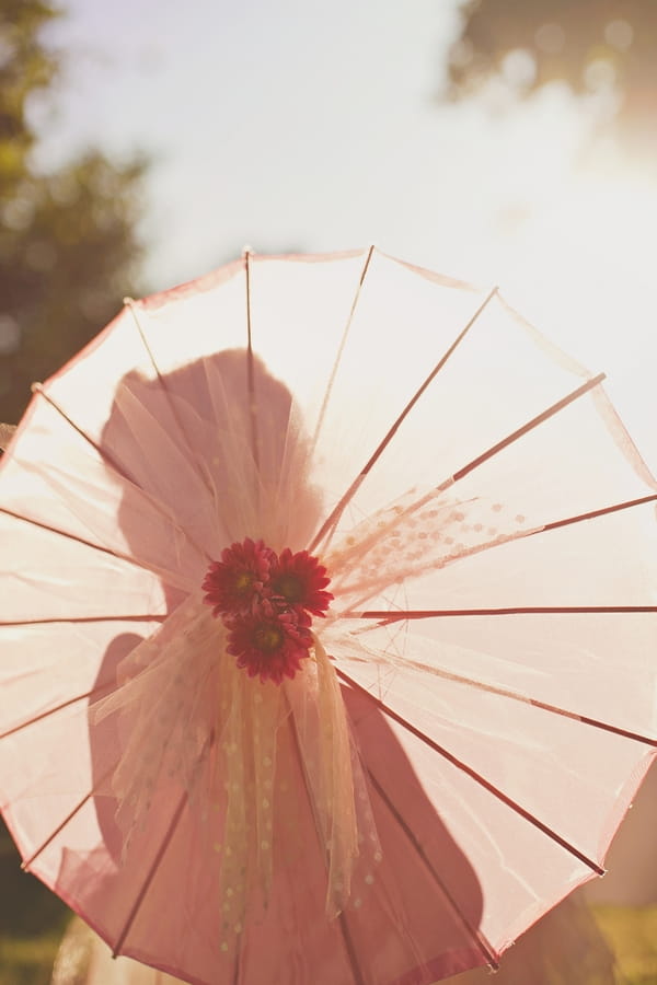 Silhouette of flowergirl through parasol - Picture by Our Labor of Love Photography