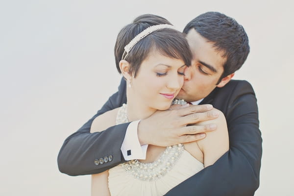 Groom with arms around bride - Picture by Our Labor of Love Photography