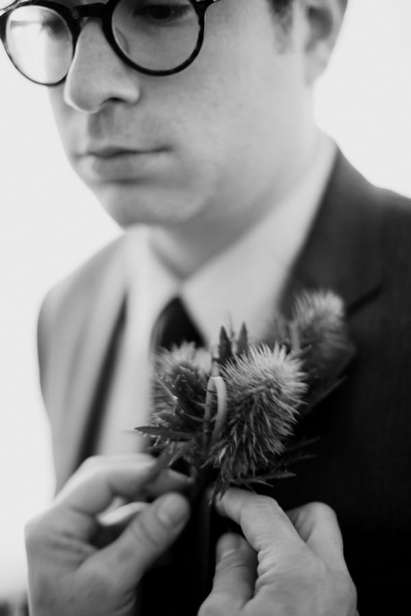Groom having buttonhole put on - Picture by Judy Pak Photography