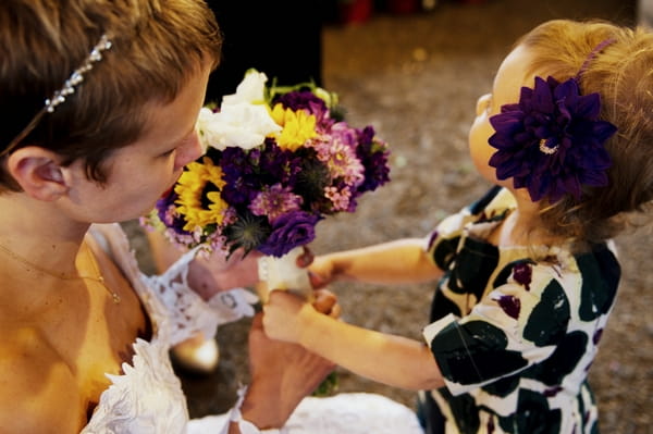 Flower girl handing bride bouquet - Picture by Judy Pak Photography