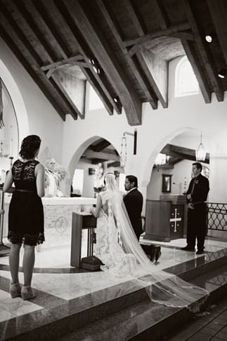 Bride and groom kneeling at altar - Picture by Joielala