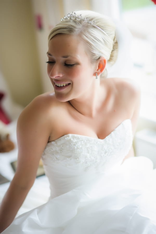 Bride sitting on bed - Picture by Pixies in the Cellar