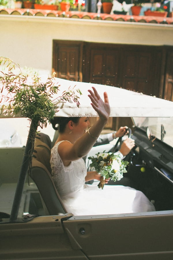 Bride waving out of window of wedding car - Picture by DanielRM