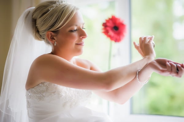 Bride rubbing pefume into her wrists - Picture by Pixies in the Cellar