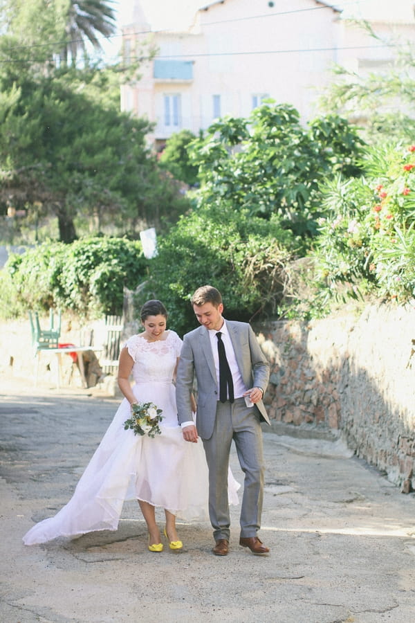 Bride and groom walking through streets of Cargese - Picture by DanielRM