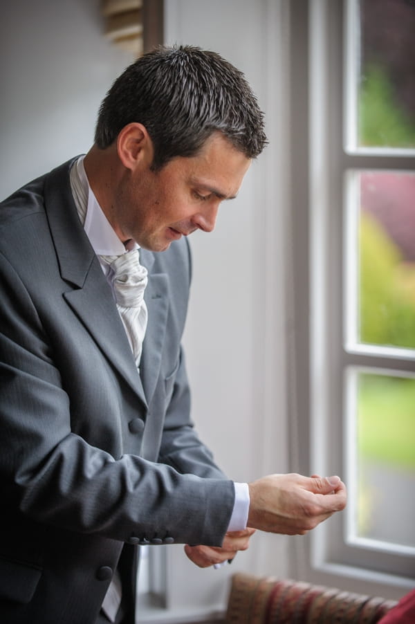 Groom doing up cufflink - Picture by Pixies in the Cellar