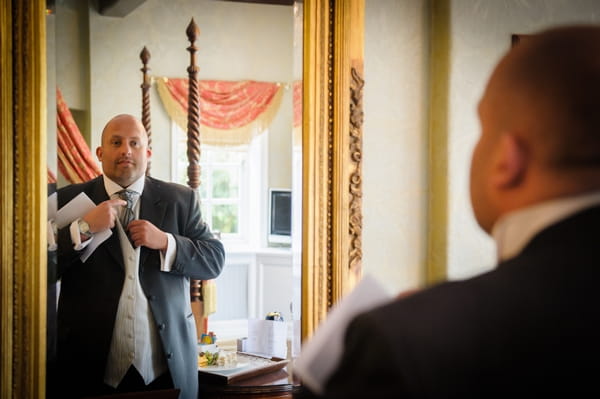 Best man adjusting cravat in mirror - Picture by Pixies in the Cellar