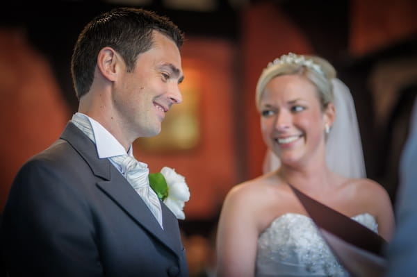 Bride and groom smiling at the altar - Picture by Pixies in the Cellar