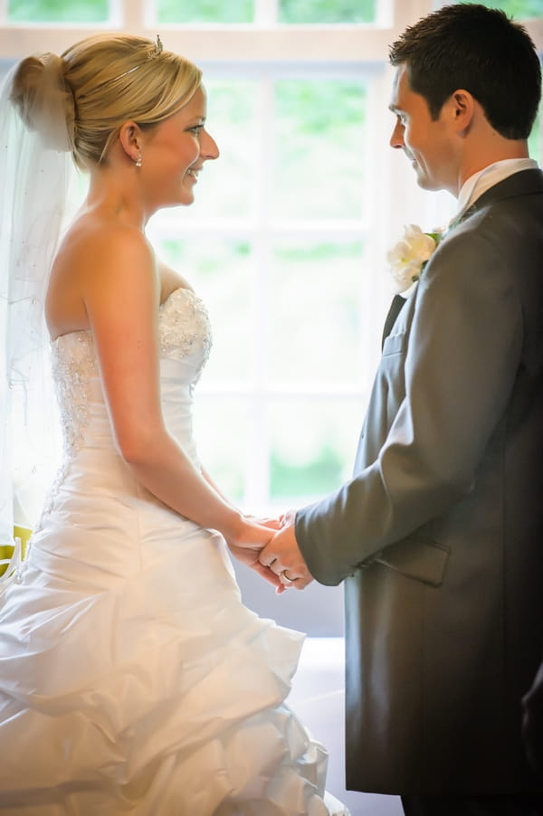 Bride and groom holding hands - Picture by Pixies in the Cellar