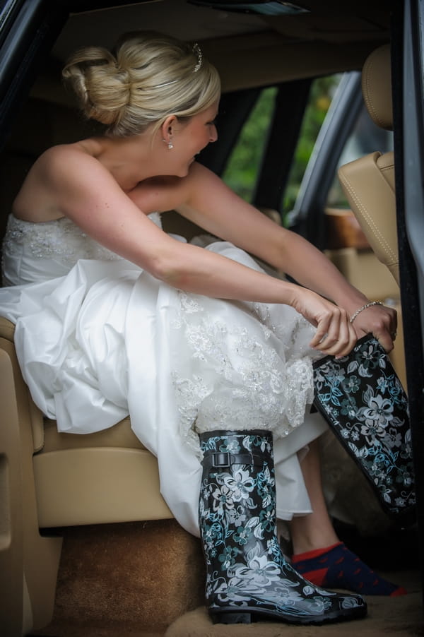 Bride putting on wellies - Picture by Pixies in the Cellar