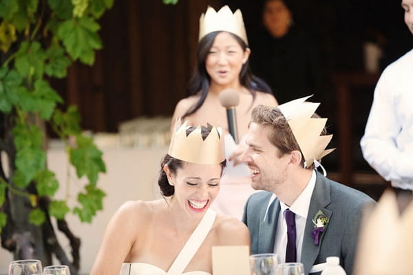 Bride and groom wearing paper crowns - Picture by Kate Harrison Photography