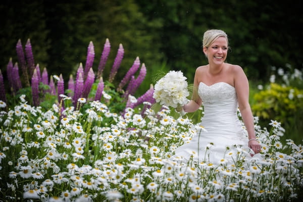 Bride standing in field of flowers - Picture by Pixies in the Cellar