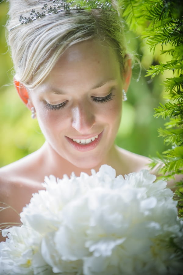 Bride looking at bouquet - Picture by Pixies in the Cellar