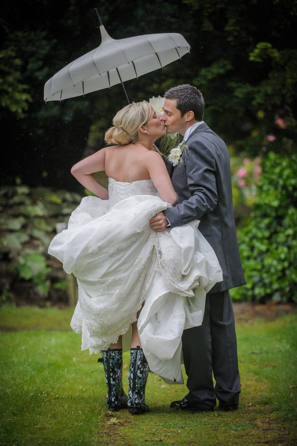 Bride and groom kissing under umbrella - Picture by Pixies in the Cellar