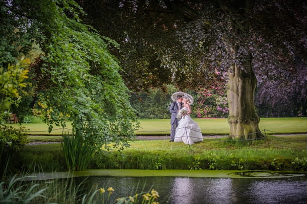 Bride and groom kissing under tree - Picture by Pixies in the Cellar