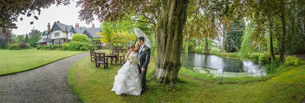 Bride resting her head on groom's shoulder under tree - Picture by Pixies in the Cellar