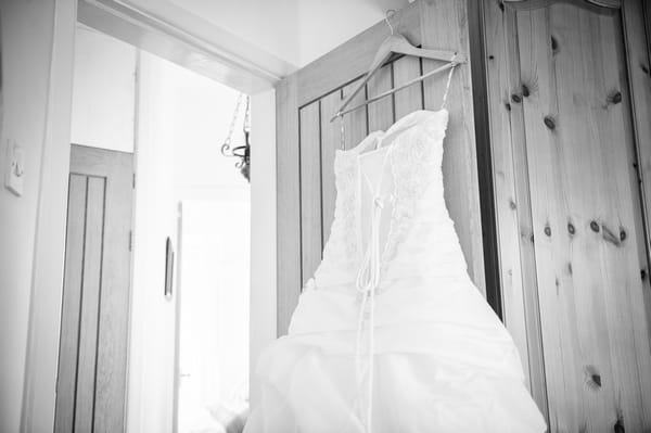 Wedding dress hanging on door - Picture by Pixies in the Cellar