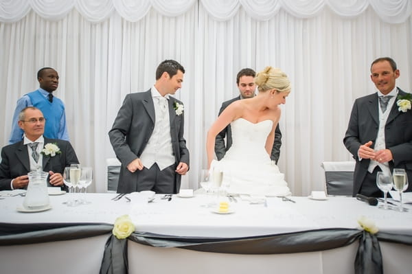 Bride and groom taking their seats for wedding breakfast - Picture by Pixies in the Cellar