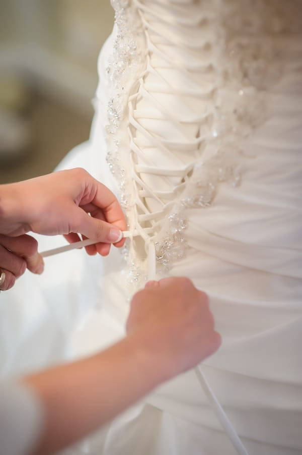 Back of wedding dress being fastened - Picture by Pixies in the Cellar